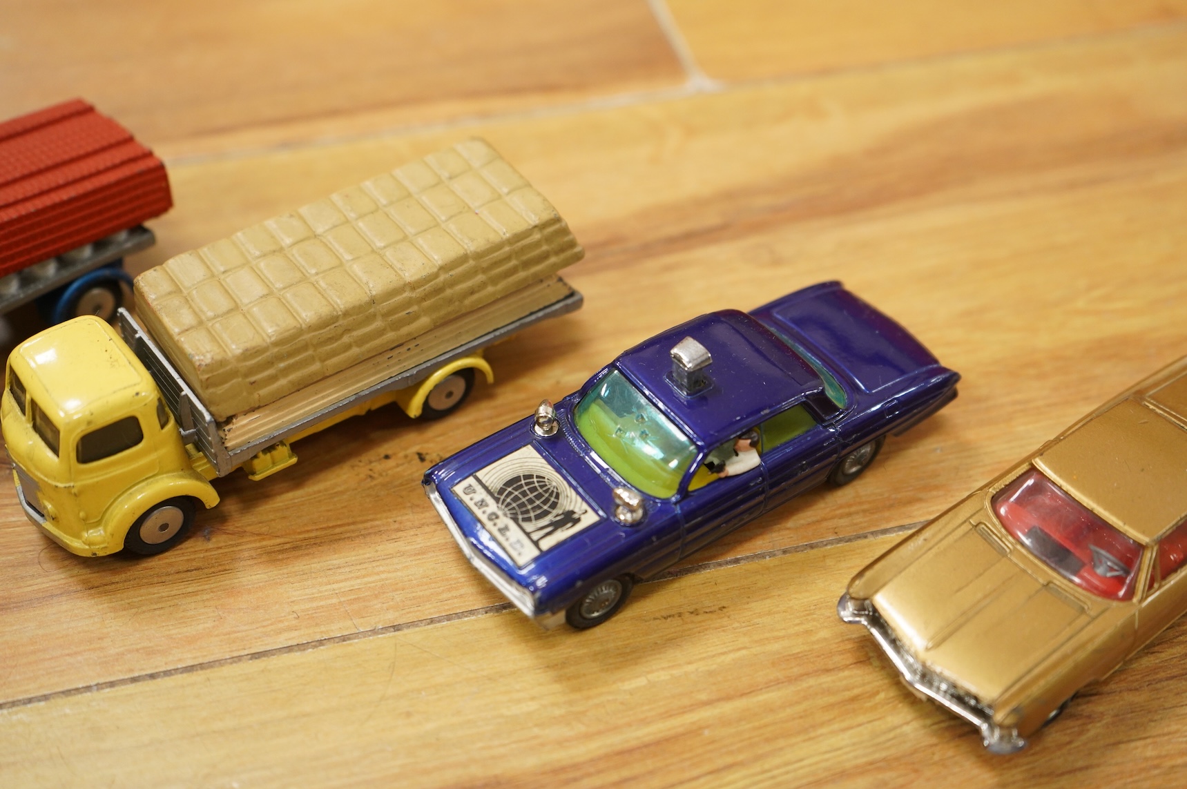 A collection of forty Corgi Toys and fourteen Matchbox Series diecast vehicles, including; The Man From Uncle Oldsmobile, a James Bond Aston Martin DB5 in gold, a Commer 5-ton truck with trailer and a selection of loads,